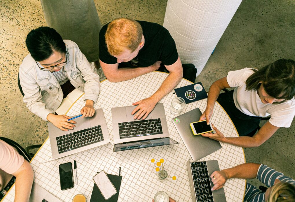 Top view of diverse team collaboratively working in a modern office setting.